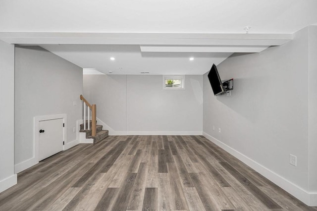 basement featuring wood finished floors, stairs, and baseboards