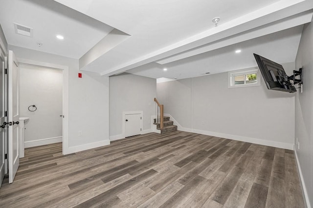 basement featuring wood finished floors, baseboards, stairway, and recessed lighting