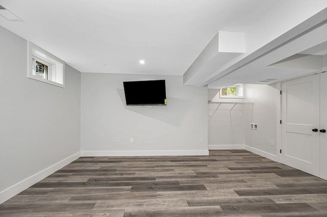 basement featuring baseboards, wood finished floors, and recessed lighting