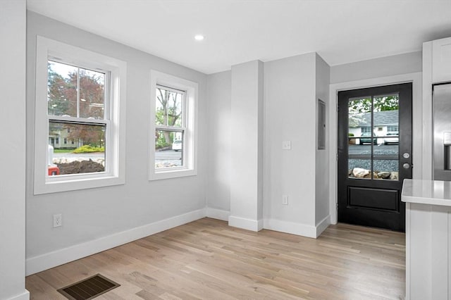 entrance foyer with baseboards, light wood-type flooring, plenty of natural light, and recessed lighting