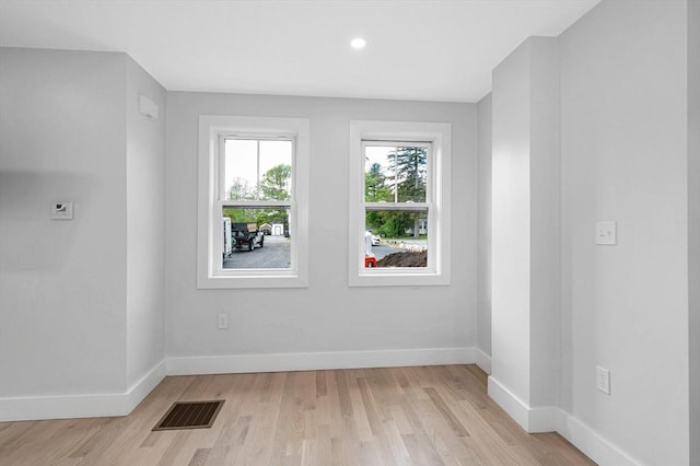 spare room featuring light wood-style flooring, baseboards, and recessed lighting