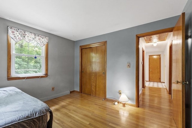 471 Lowell St, Reading, MA 01867 - bedroom with light wood-type flooring, a baseboard radiator, attic access, and a closet
