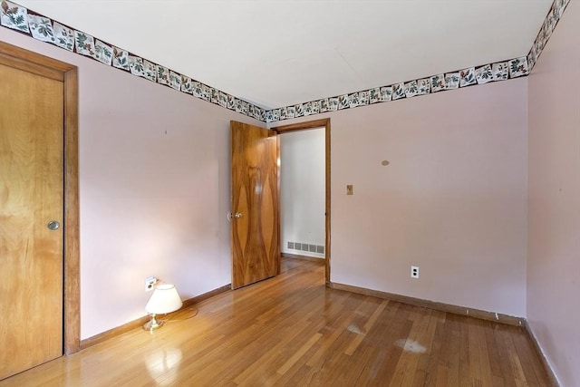 471 Lowell St, Reading, MA 01867 - spare room with wood finished floors and baseboards