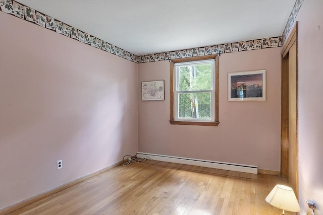 471 Lowell St, Reading, MA 01867 - spare room featuring a baseboard heating unit and light wood-type flooring