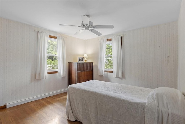 471 Lowell St, Reading, MA 01867 - bedroom featuring wood finished floors, wallpapered walls, and ceiling fan