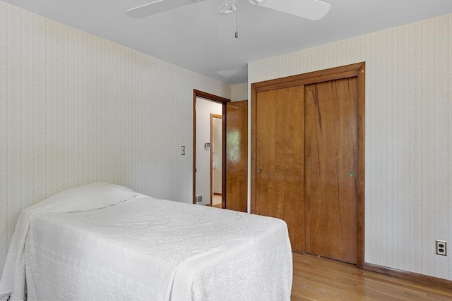 471 Lowell St, Reading, MA 01867 - bedroom with light wood-style flooring, a closet, a ceiling fan, and wallpapered walls