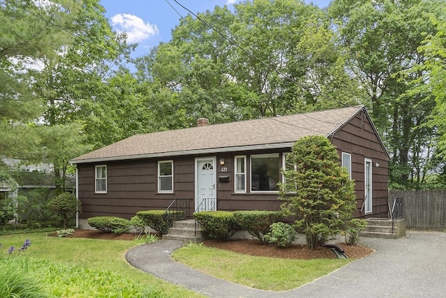 471 Lowell St, Reading, MA 01867 - view of front of home with roof with shingles and a chimney