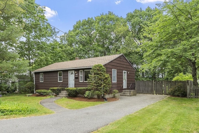 471 Lowell St, Reading, MA 01867 - view of front of home featuring driveway, a shingled roof, and a chimney