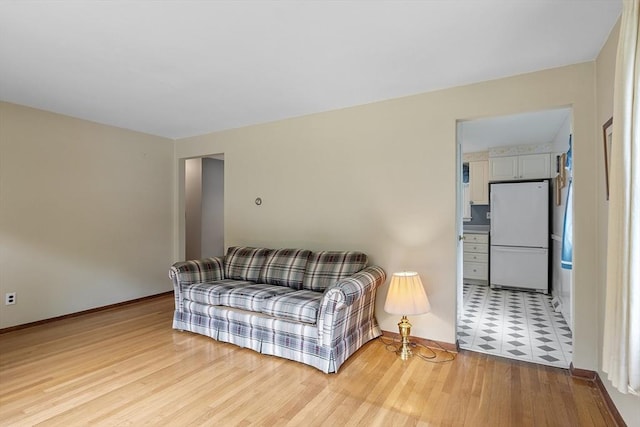 471 Lowell St, Reading, MA 01867 - living area with light wood-style flooring and baseboards