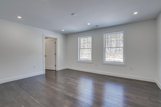 unfurnished room with dark hardwood / wood-style flooring