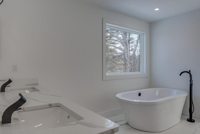 bathroom with a bathing tub and sink