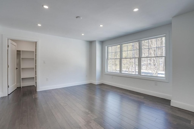 unfurnished room with dark hardwood / wood-style flooring