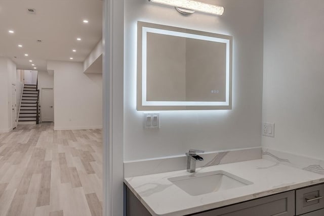 bathroom with vanity and hardwood / wood-style floors