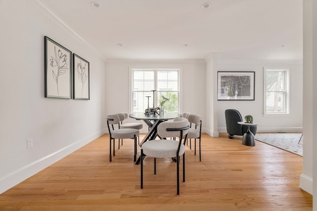 dining room featuring ornamental molding and light hardwood / wood-style flooring