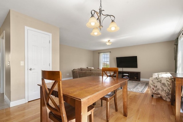 161 Bear Hole Rd, West Springfield, MA 01089 - dining area featuring baseboards, light wood-style flooring, and a notable chandelier