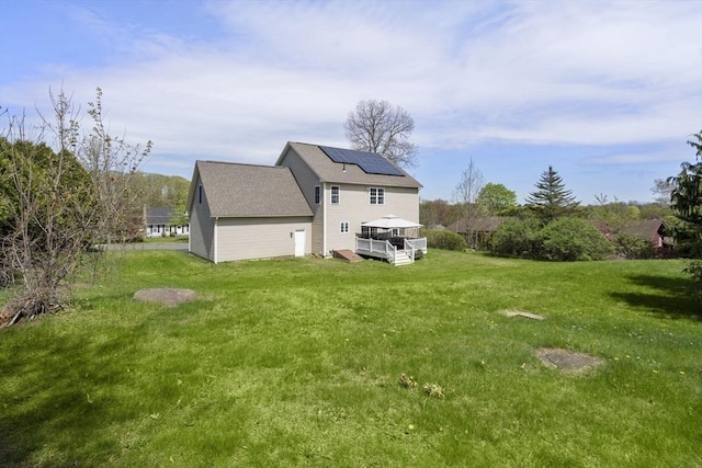 161 Bear Hole Rd, West Springfield, MA 01089 - back of property with roof with shingles, a wooden deck, a yard, and solar panels