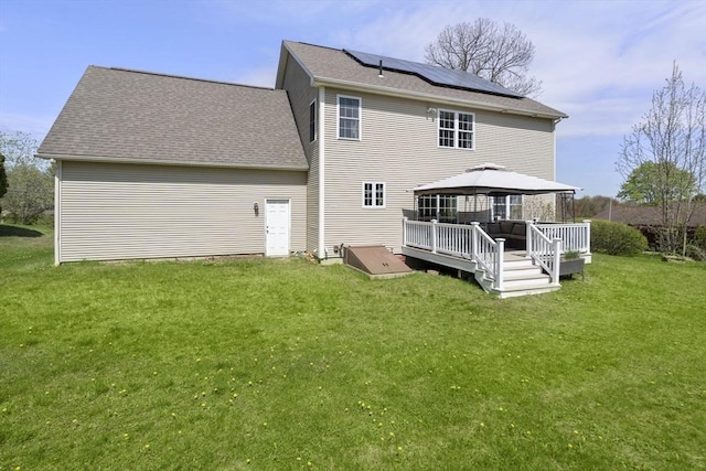 161 Bear Hole Rd, West Springfield, MA 01089 - back of house with a lawn, a gazebo, a wooden deck, and roof mounted solar panels