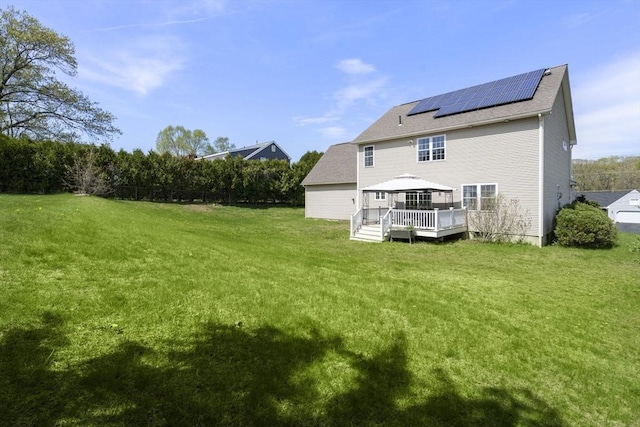 161 Bear Hole Rd, West Springfield, MA 01089 - back of property with a shingled roof, a gazebo, a deck, solar panels, and a yard