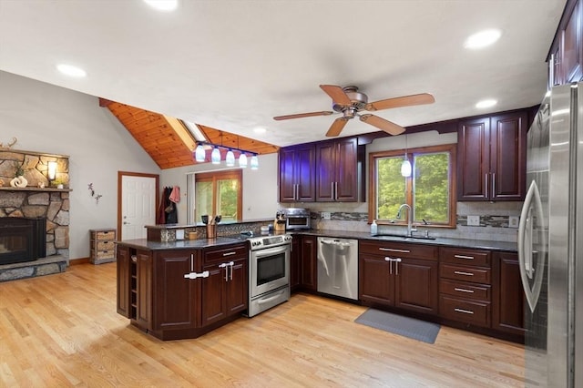 50 New Jersey Rd, Tewksbury, MA 01876 - kitchen featuring stainless steel appliances, a sink, a peninsula, decorative backsplash, and light wood-style floors