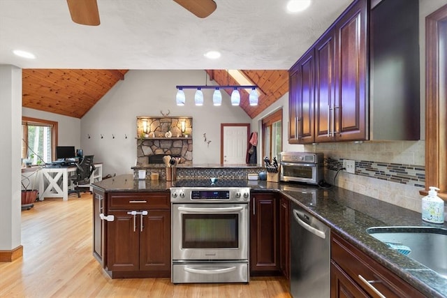 50 New Jersey Rd, Tewksbury, MA 01876 - kitchen with stainless steel appliances, vaulted ceiling, ceiling fan, a peninsula, and tasteful backsplash