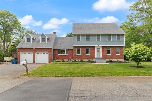 50 New Jersey Rd, Tewksbury, MA 01876 - view of front of home featuring brick siding, driveway, a chimney, and a front yard