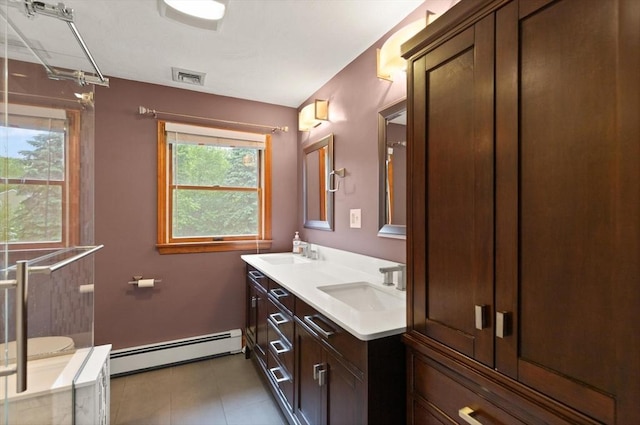 50 New Jersey Rd, Tewksbury, MA 01876 - bathroom with baseboard heating, double vanity, plenty of natural light, and tile patterned flooring