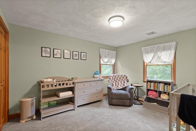 50 New Jersey Rd, Tewksbury, MA 01876 - bedroom with carpet, a textured ceiling, a baseboard radiator, a nursery area, and baseboards