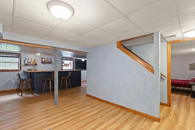 50 New Jersey Rd, Tewksbury, MA 01876 - below grade area with a paneled ceiling, wood finished floors, bar, and baseboards