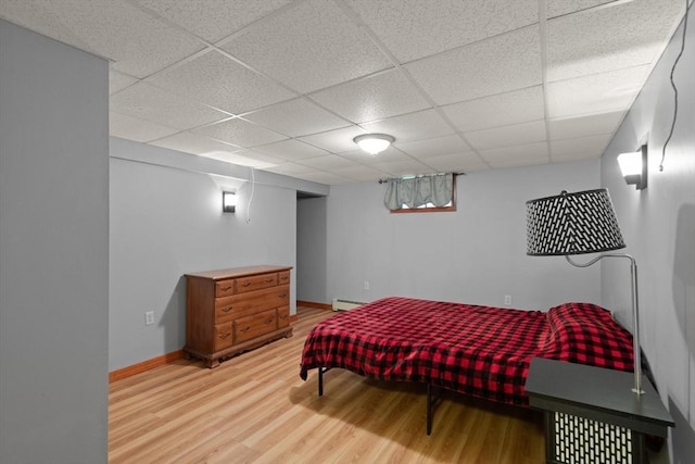 50 New Jersey Rd, Tewksbury, MA 01876 - bedroom with light wood-type flooring, a paneled ceiling, a baseboard heating unit, and baseboards