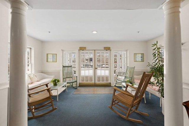 interior space with carpet flooring, decorative columns, french doors, and a healthy amount of sunlight