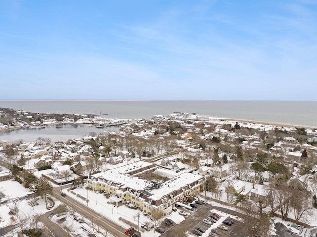 snowy aerial view featuring a water view