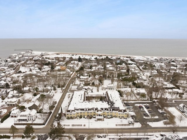 snowy aerial view featuring a water view