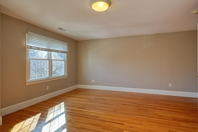 unfurnished room with light hardwood / wood-style flooring