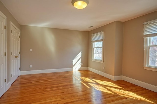 spare room featuring light wood-type flooring