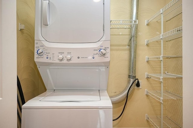 laundry room with stacked washer / dryer