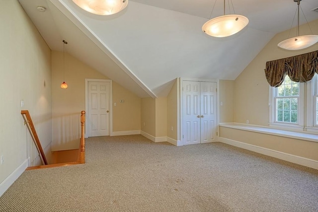 bonus room featuring vaulted ceiling and carpet