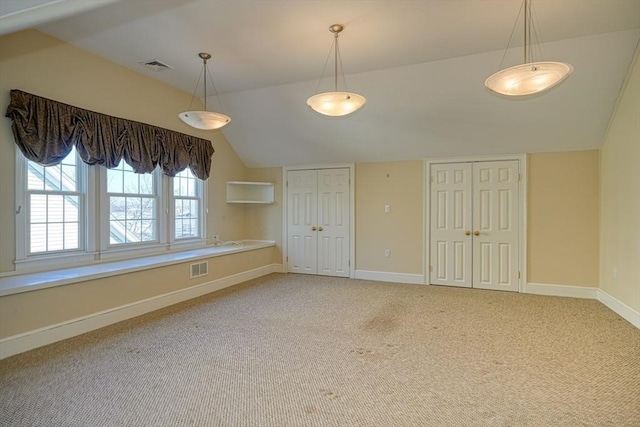 interior space featuring vaulted ceiling and carpet