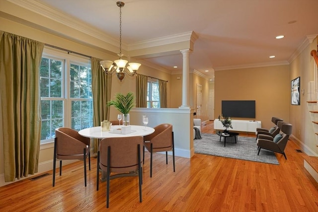 dining area with ornamental molding, a wealth of natural light, light hardwood / wood-style flooring, and decorative columns