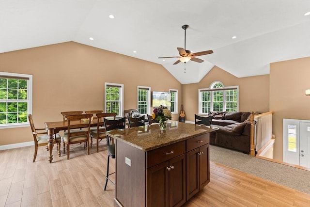 33 Beaver St, Whitman, MA 02382 - kitchen with vaulted ceiling, a kitchen bar, light wood finished floors, open floor plan, and a ceiling fan