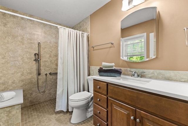 33 Beaver St, Whitman, MA 02382 - bathroom with vanity, toilet, tiled shower, tile patterned flooring, and tile walls