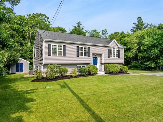 33 Beaver St, Whitman, MA 02382 - split foyer home with a front yard, central air condition unit, an outbuilding, and roof with shingles