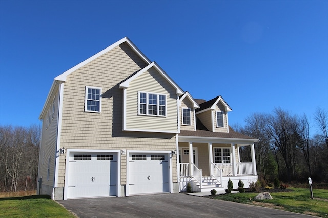 view of front of property featuring covered porch and a garage