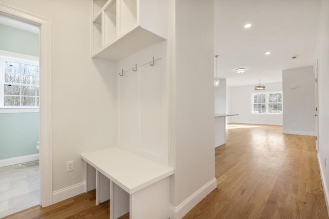 mudroom with light hardwood / wood-style floors