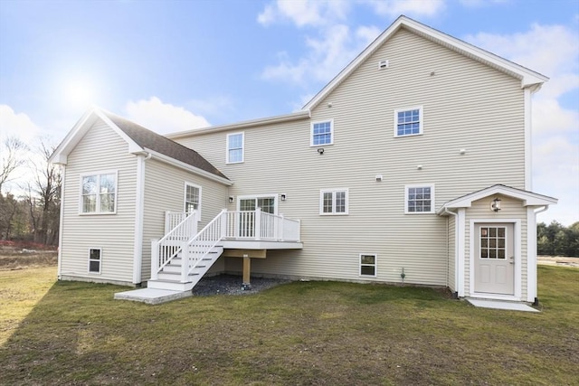 rear view of house with a yard and a deck