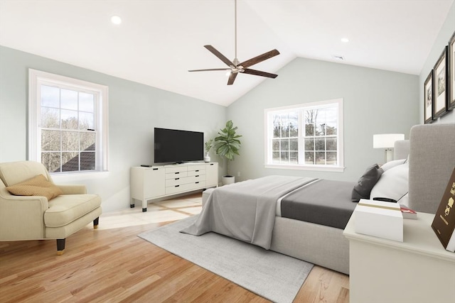 bedroom featuring multiple windows, vaulted ceiling, light hardwood / wood-style flooring, and ceiling fan