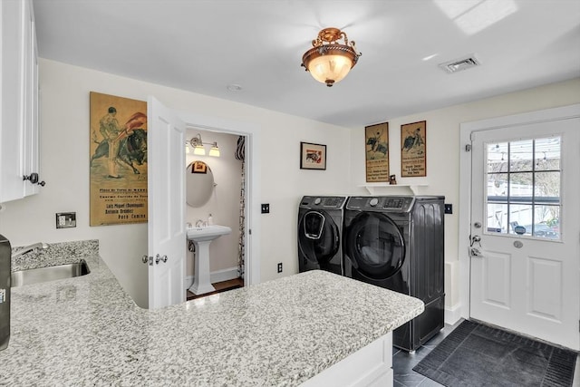 40 Pleasant St, Dover, MA 02030 - clothes washing area featuring washing machine and clothes dryer, visible vents, a sink, and cabinet space