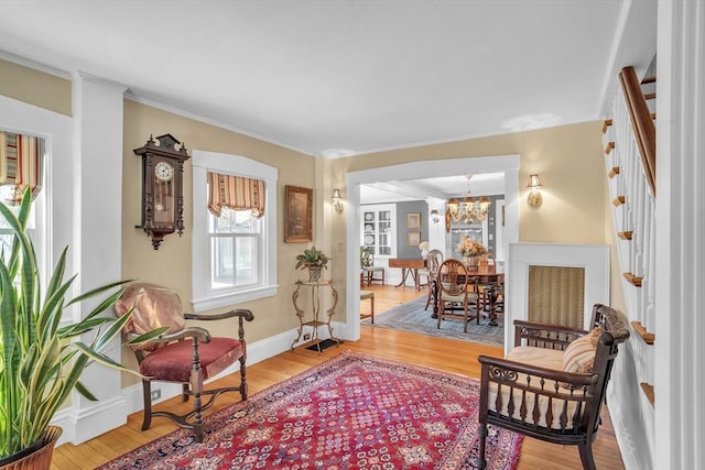 40 Pleasant St, Dover, MA 02030 - sitting room featuring crown molding, a notable chandelier, light wood-style flooring, baseboards, and stairway