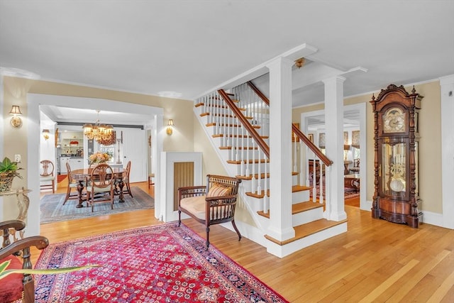 40 Pleasant St, Dover, MA 02030 - interior space with crown molding, ornate columns, an inviting chandelier, and wood finished floors