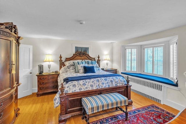 40 Pleasant St, Dover, MA 02030 - bedroom featuring multiple windows, radiator heating unit, and light wood-style flooring