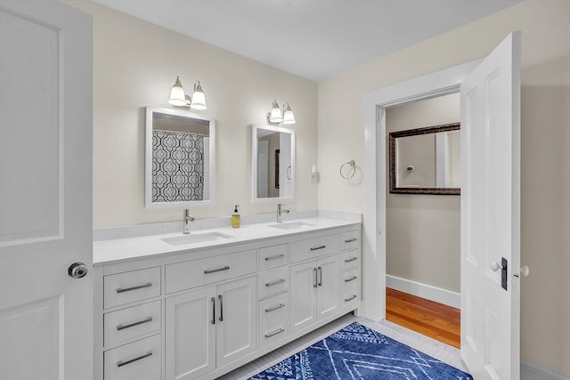 40 Pleasant St, Dover, MA 02030 - full bath featuring a sink, baseboards, and double vanity
